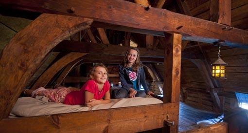 Two children sitting on bunk beds.