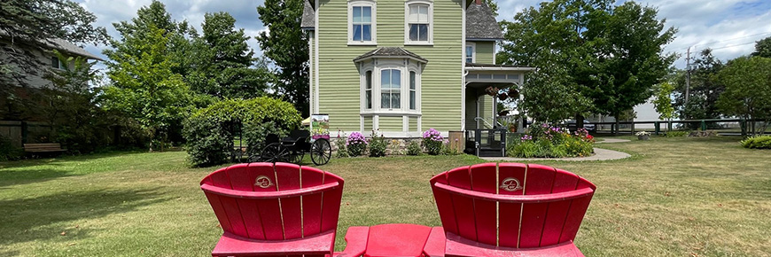 Red chairs and a historic house