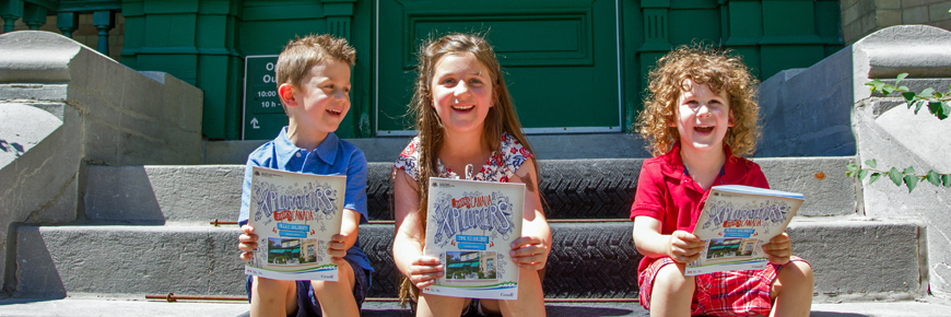 Children laugh as they do activities in the xplorers activity books