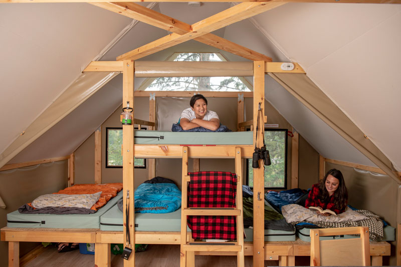 Campers enjoy the comfortable beds in an oTENTik