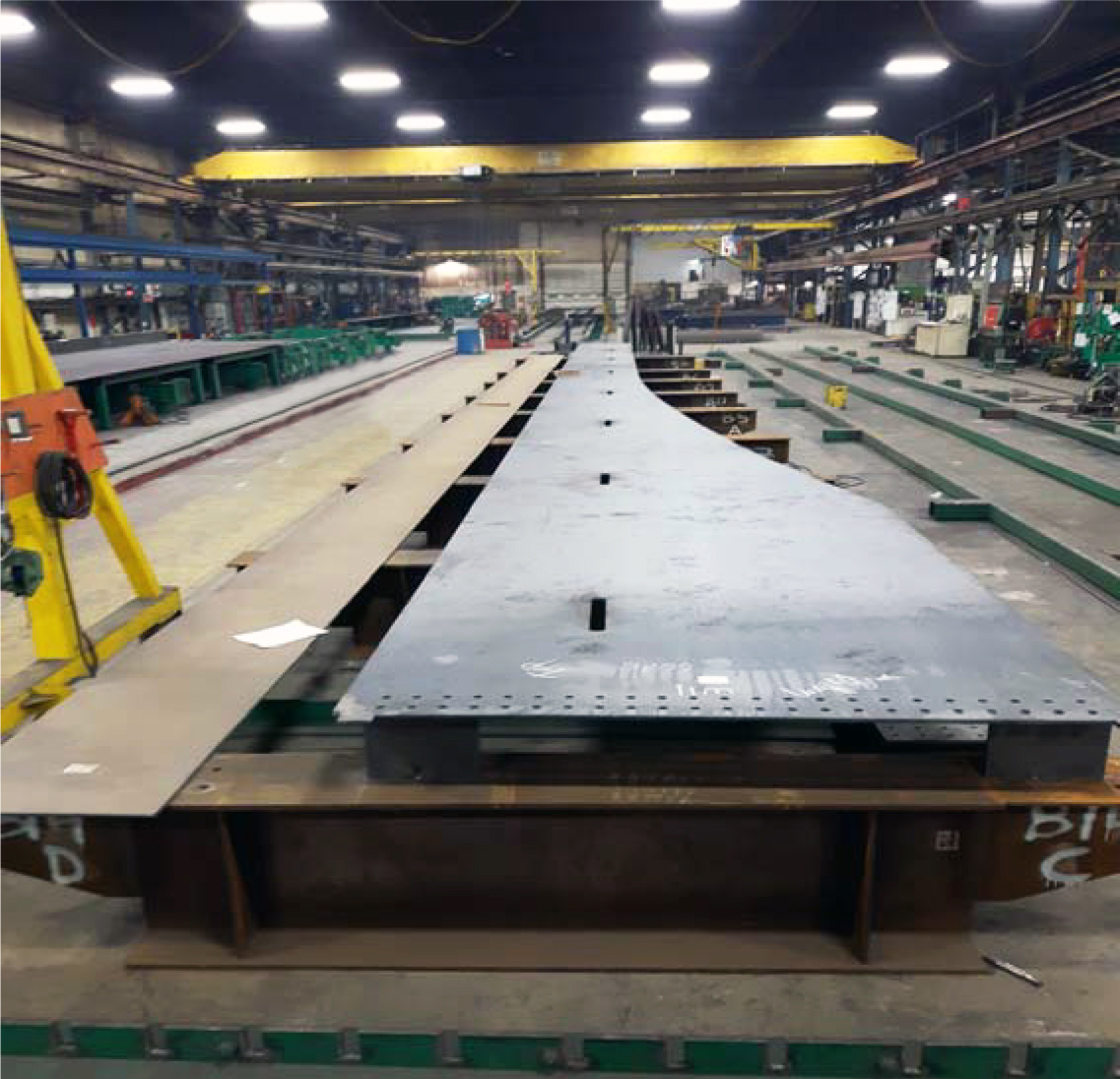 A shape of flat steel on its side in a machine shop.