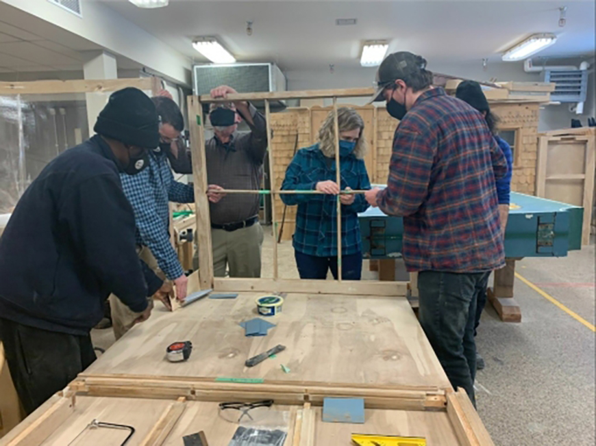 Students working on building a window.