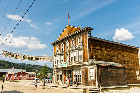 Visitors in front of the Palace Grand Theatre at Dawson Historical Complex National Historic Site.