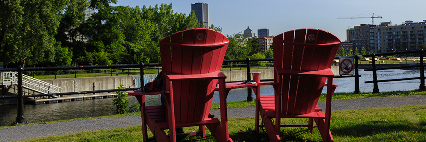 Red chairs near Lachine Canal