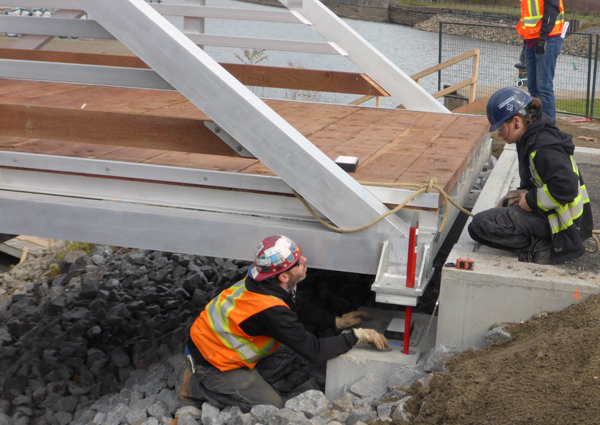 Two workers fixing the footbridge