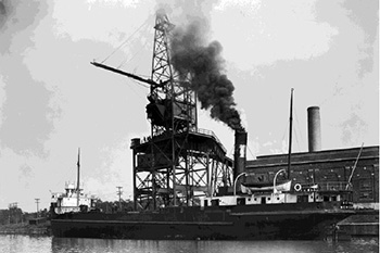 Black and white picture of a coal plant installation and the Lachine canal