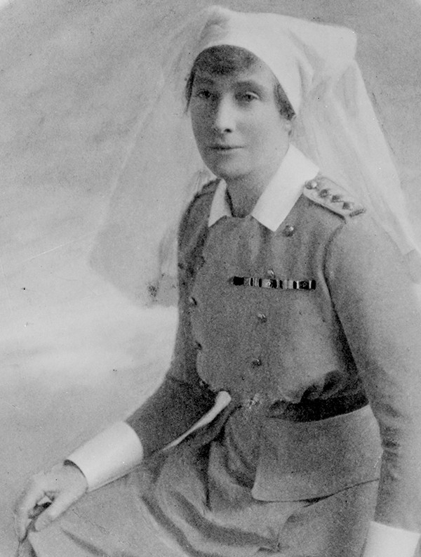 Black and white photo of a woman with an army uniform