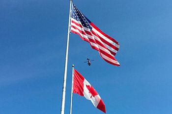 An american and a canadian flag
