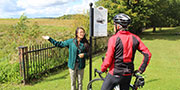 Une guide de Parcs Canada s'entretenant avec un cycliste