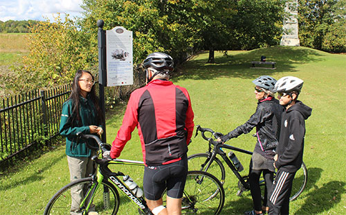 Une guide de Parcs Canada parle avec des cyclistes