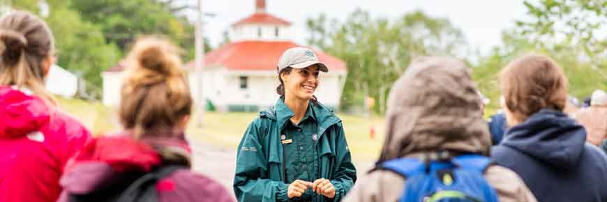 Parks Canada Guide Talking to a group of visitors in the rain.