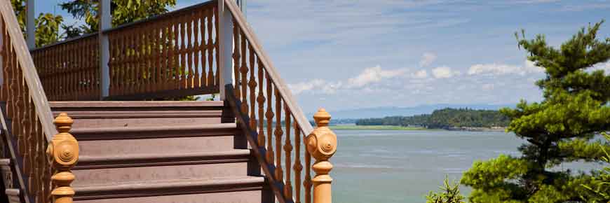 A staircase leading to a porch overlooking the water.