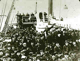a large group of immigrants on the deck of a boat