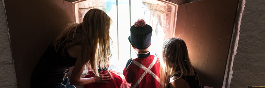 a family looking through a window at fort no.1