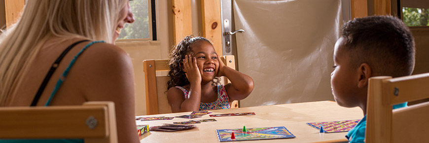 a little girl playing a board game