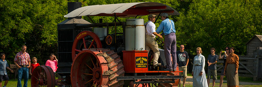 Visitors watch a demonstration with the 1911 Hart Parr tractor
