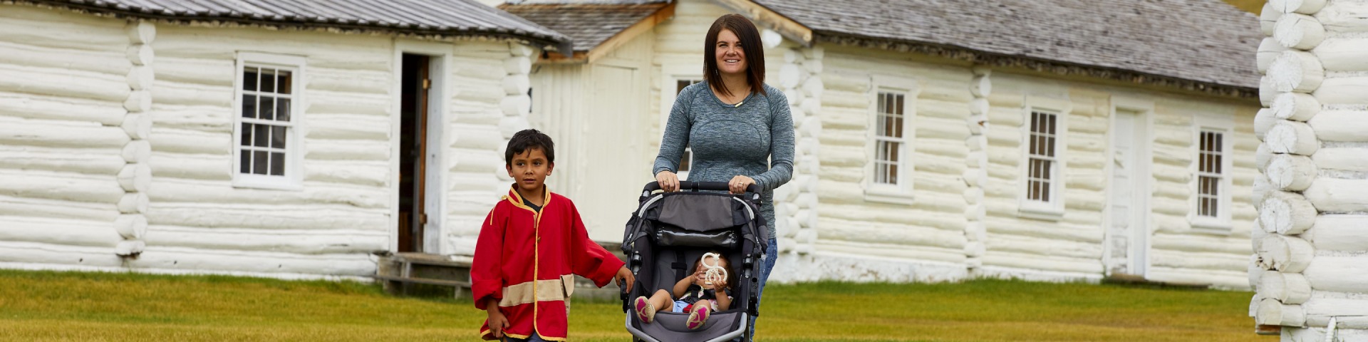 A family walking through the Fort with a stroller.