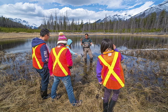 volunteers out in the field with parks canada staff member