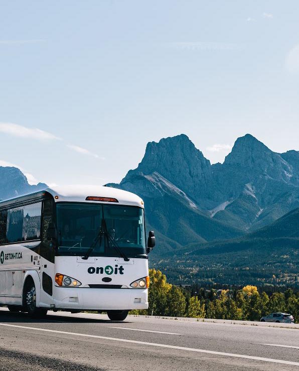 An On-IT bus driving down a mountain highway