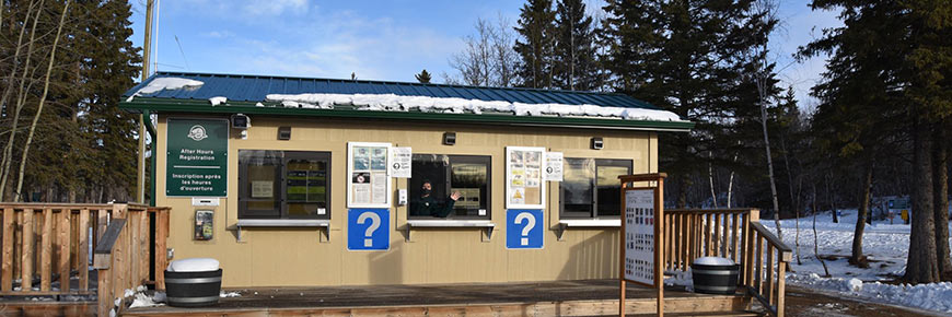 Park staff greets visitors from campground kiosk