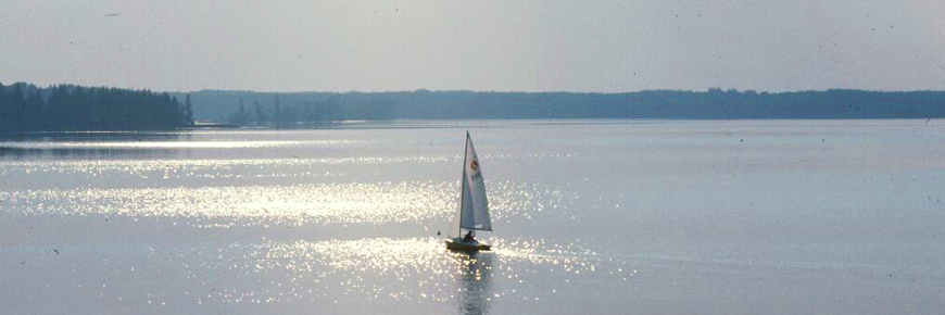 A sailboat glides across Astotin Lake.