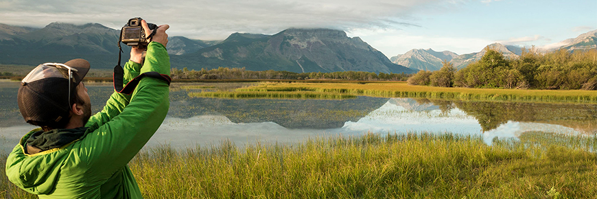A photographer takes a shot of the Waterton landscape