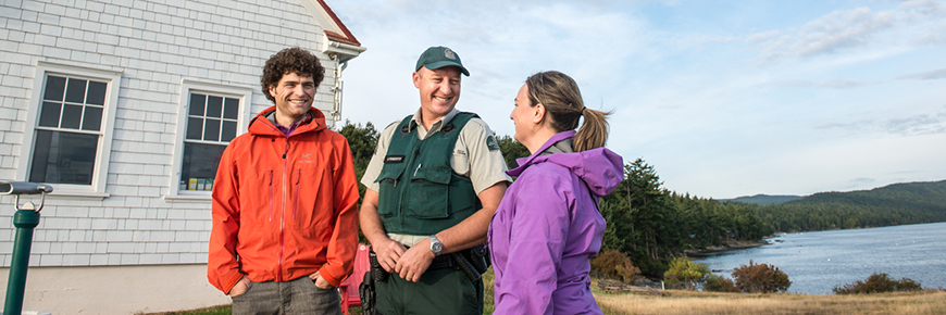 A national park warden talks to two visitors.