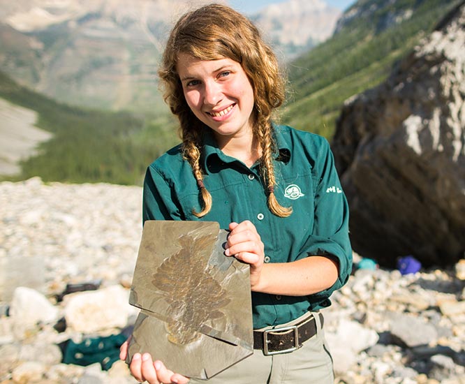 Parks Canada guide holding a fossil