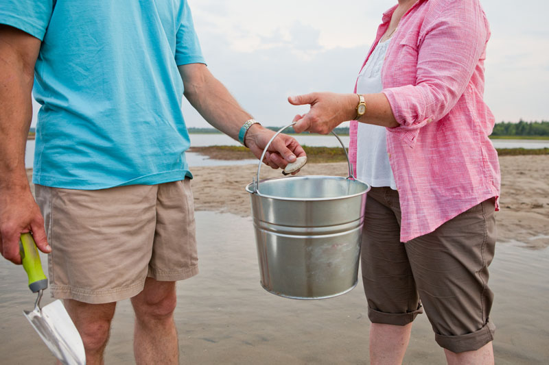Two people fishing clams