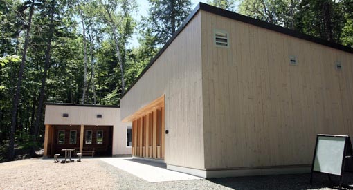 Concrete pad leads to the picnic shelter and the barrier-free, accessible washroom.