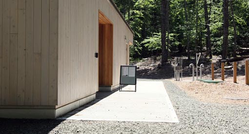 Entrance to the picnic shelter with paved entrance surrounded by crushed gravel.