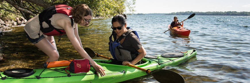 A pair prepare their kayak for a day on the water. 