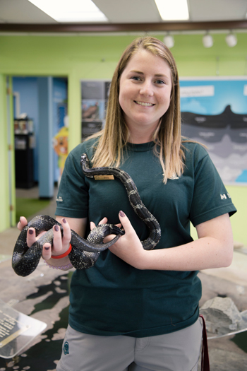 Park staff with a gray rat snake