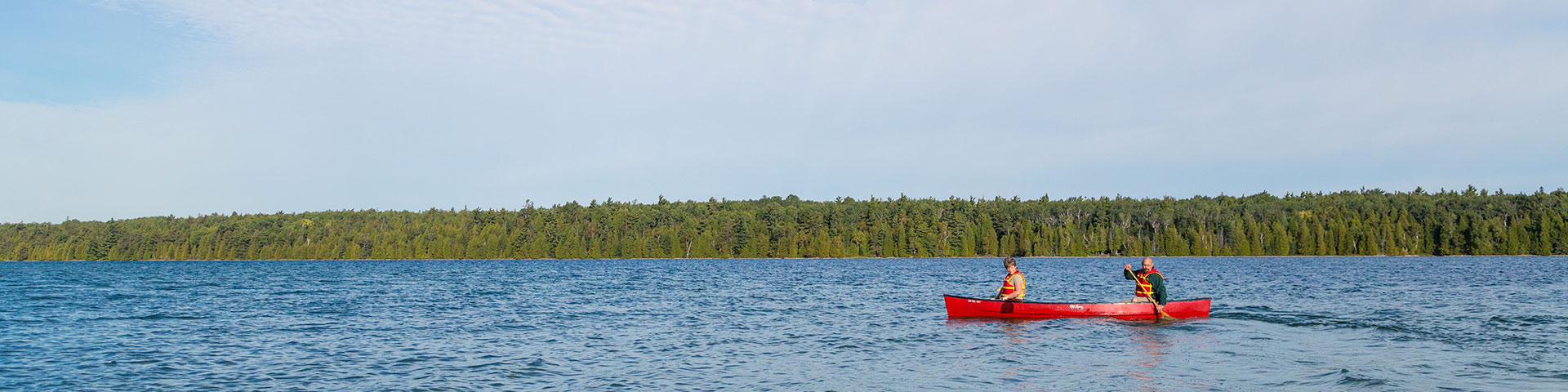 A red canoe on a lake.