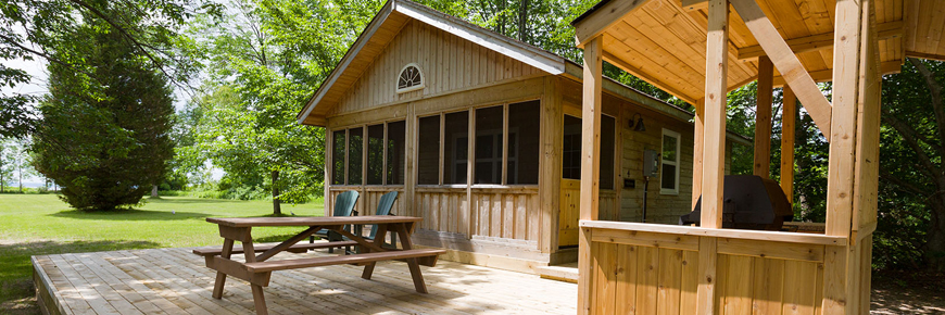 A large deck in front of the family cabins at Cedar Spring campground. 