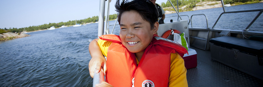 A child enjoys a boat ride. 