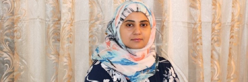 Portrait of Shazeia on beige backdrop.