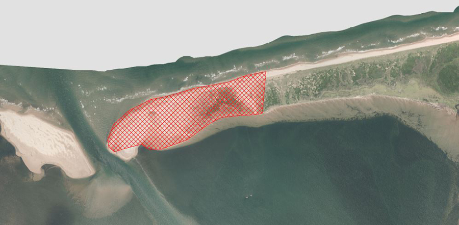Aerial photo with closure area marked with red.