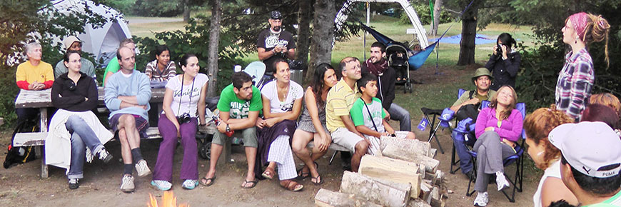 group of campers listening to a woman