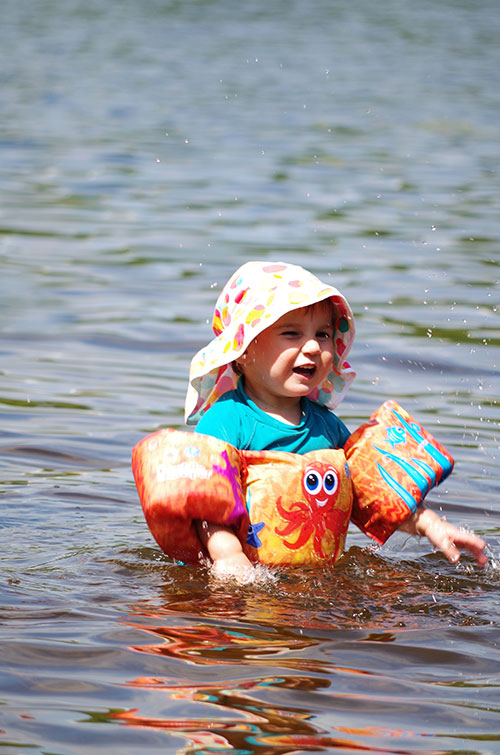 A child with floats is bathing