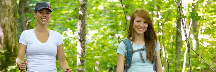 Two young women hiking in the woods