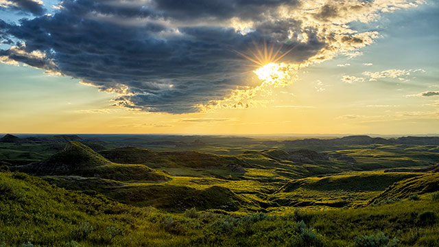 The sun sets on the rugged hills of the badlands in the East Block