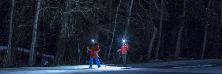Cross-country skiing at night with head lamps