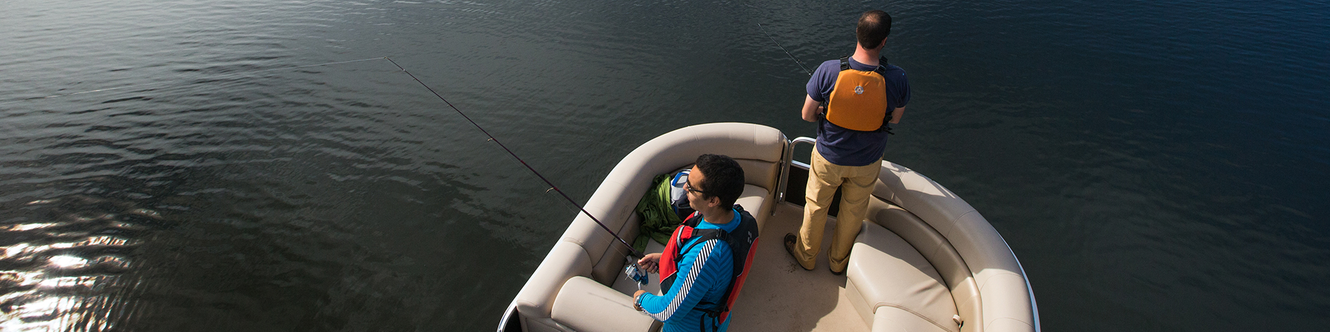 A group of visitors go fishing in a fishing boat on Waskesiu Lake during a summer day in Prince Albert National Park.