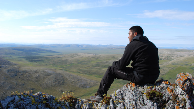 A visitor enjoys the view of the vast tundra below