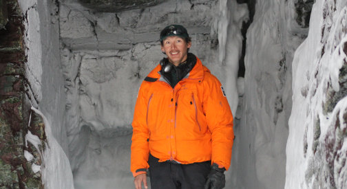 Young man in bright orange jacket.